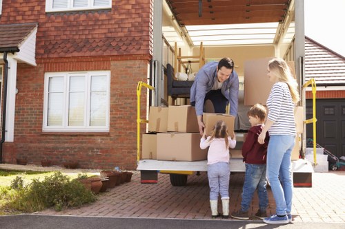Professional movers loading boxes for a West London house move