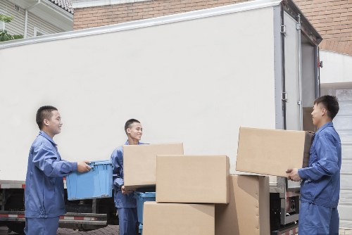 Professional moving team loading items into a van in Earlscourt